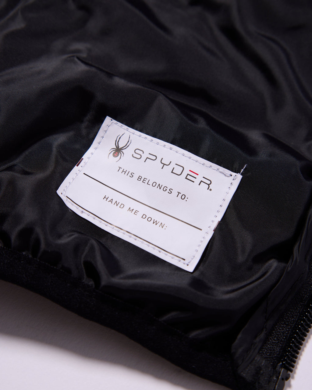 Spyder label on a black jacket