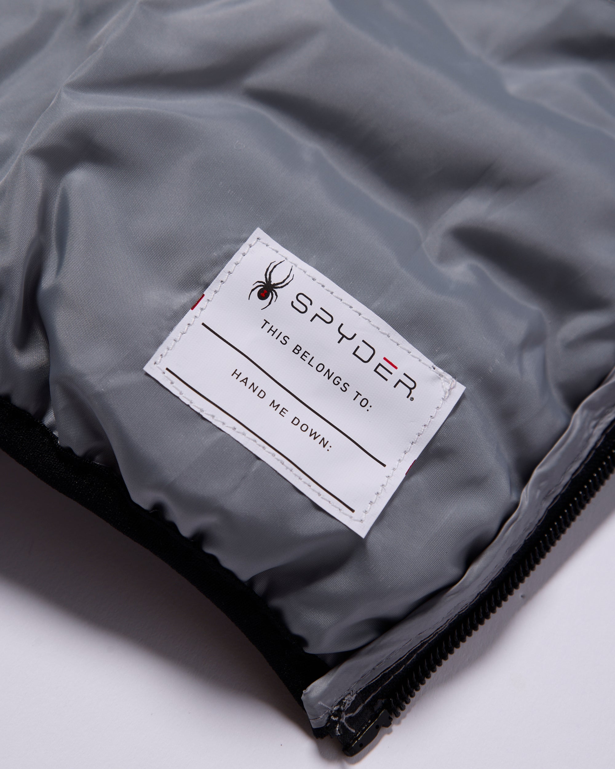 Gray jacket with a Spyder label on a white background