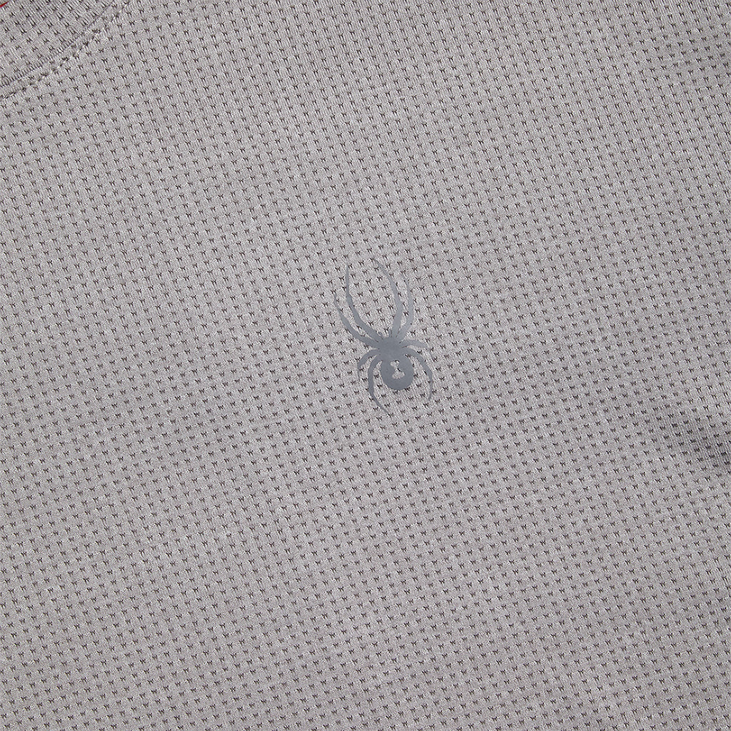 Close-up of a textured gray fabric with a small logo.
