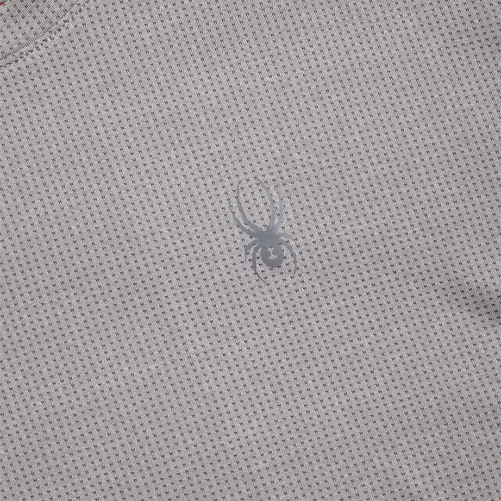 Close-up of a textured gray fabric with a small logo.